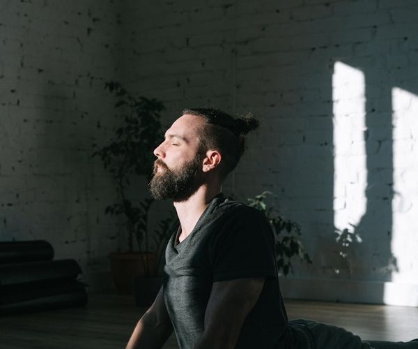 A man meditating after a workout, showing focus and inner calm.